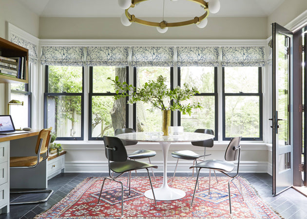Dining nook with tulip table and black trimmed windows