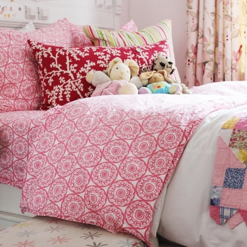 Sophie's Bed with patterned pink comforter and Pillows