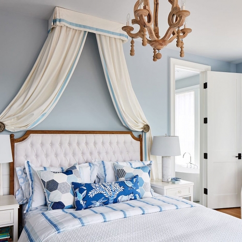 Bed with blue patterned curtain