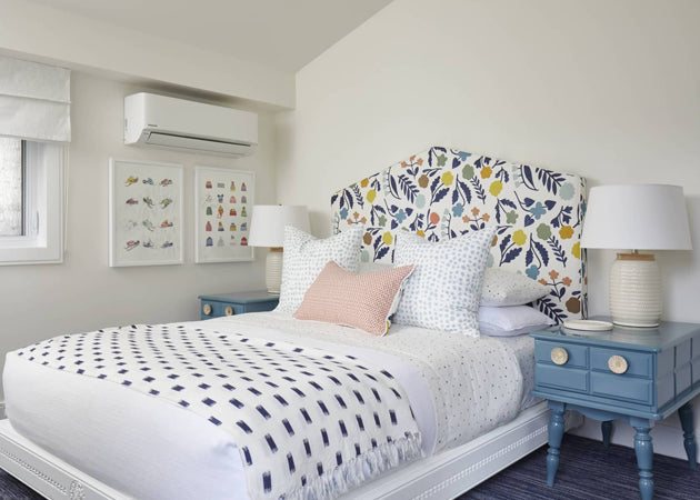 Bed with colourful blue, white and coral upholstered headboard