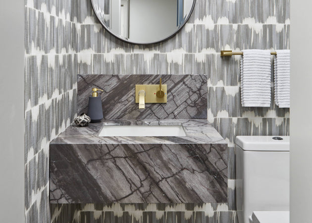 Charcoal grey powder room with floating vanity and graphic wallpaper