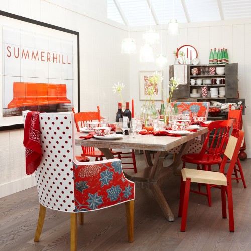 A summerhill subway sign poster hangs on the wall in front of a very funky and fun dining room table. 