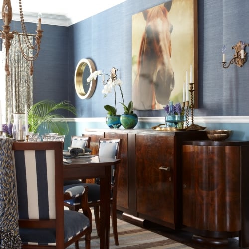 Image showing off the contrasting artwork on the walls along with the wooden serving hutch